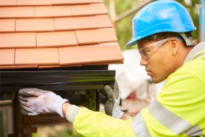 Gutter installation by a worker